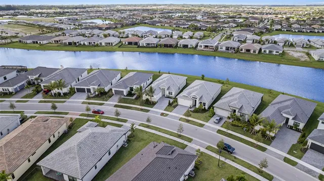 an aerial view of a house with a swimming pool yard and outdoor seating