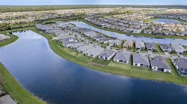 an aerial view of residential houses with outdoor space and swimming pool