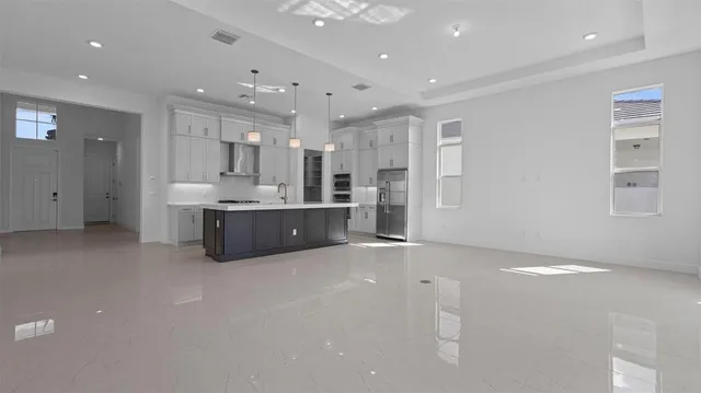 a view of kitchen and kitchen with stainless steel appliances