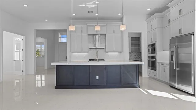 a bathroom with a sink shower and a mirror