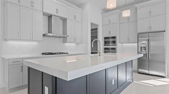 a kitchen with stainless steel appliances a refrigerator and cabinets