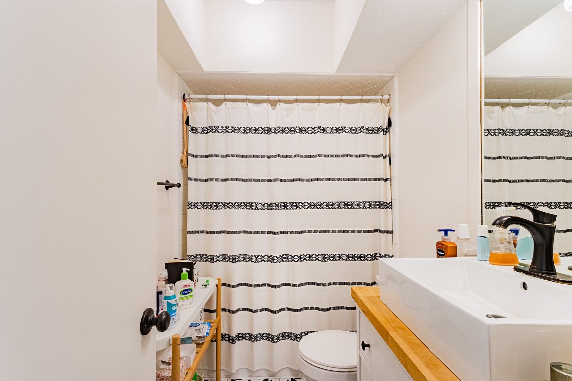 606 Enid Street, Unit 3 Houston, TX 77009 - Photo 14 of 42 a bathroom with a sink a toilet and shower curtain