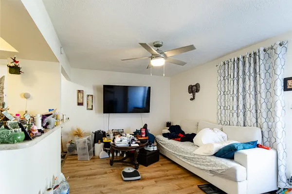 a room with lots of chairs and a fan