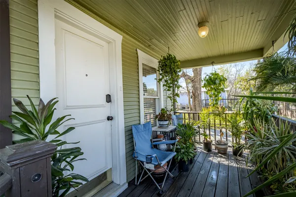 a view of a house with a porch and furniture