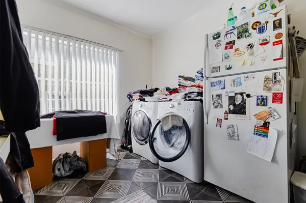 a kitchen view with appliances a sink and cabinets