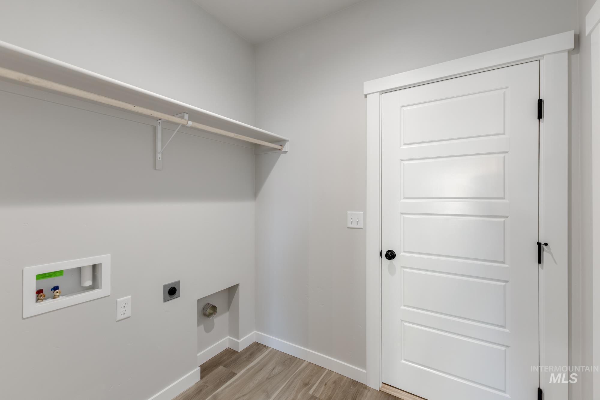 10574 West Teratai Street Star, ID 83669 - Photo 11 of 23 Washroom with light wood-type flooring, hookup for an electric dryer, and washer hookup