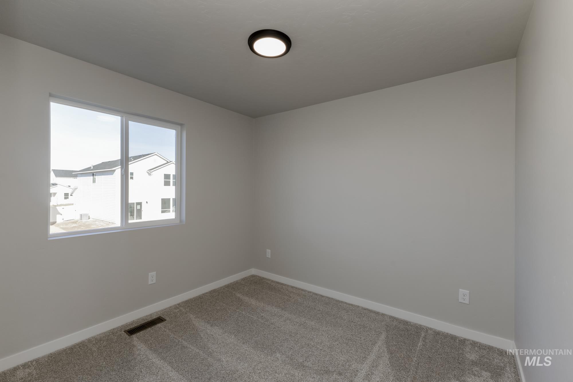 10574 West Teratai Street Star, ID 83669 - Photo 15 of 23 Carpeted spare room featuring baseboards
