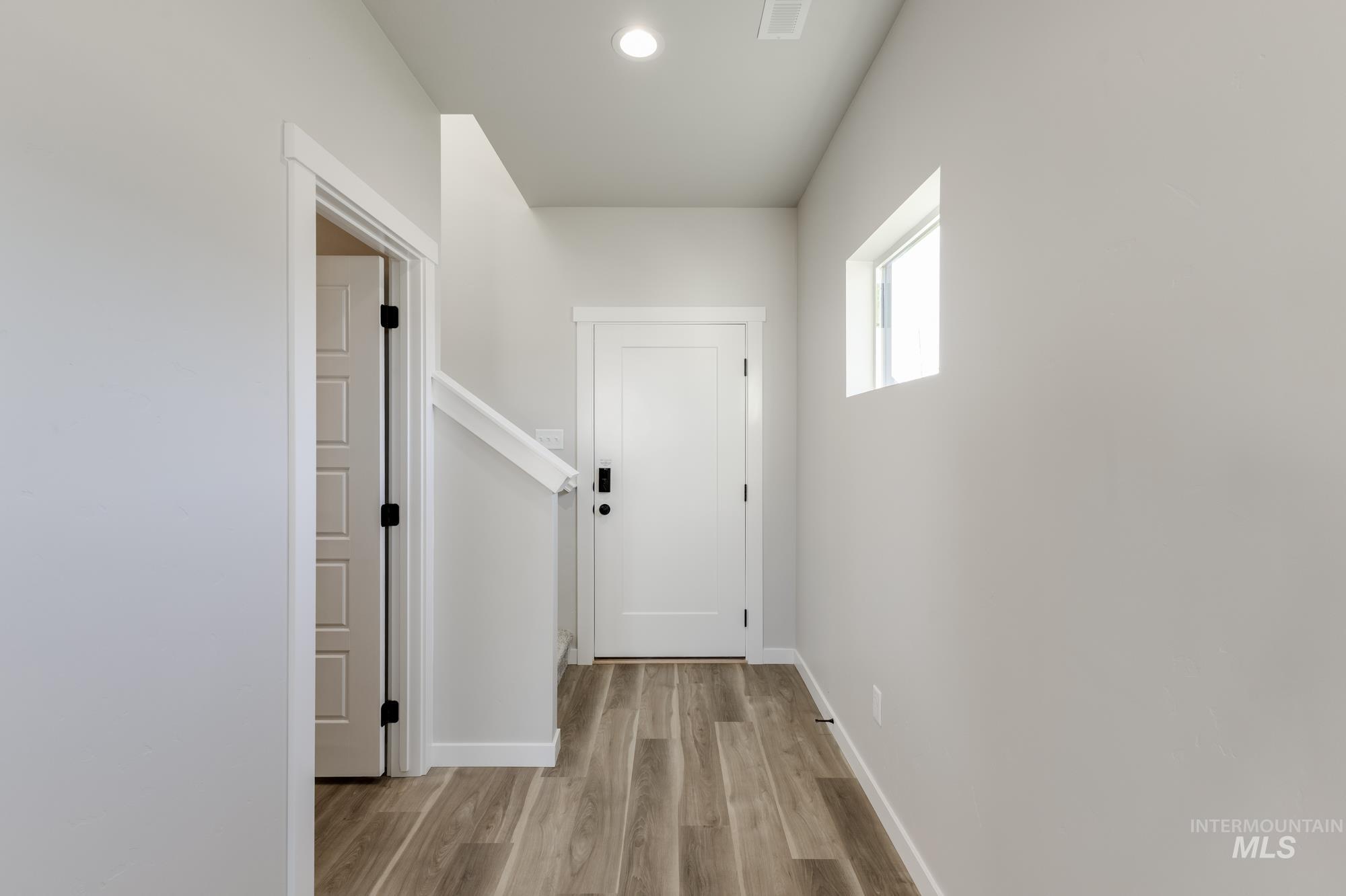 10574 West Teratai Street Star, ID 83669 - Photo 3 of 23 Corridor with light wood-style floors and recessed lighting