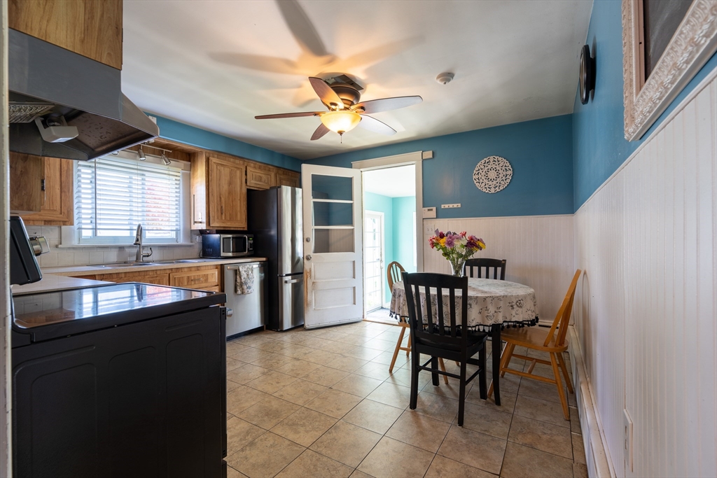 110 James M Beardsworth Road Tiverton, RI 02878 - Photo 14 of 26 a kitchen with stainless steel appliances granite countertop a dining table and chairs