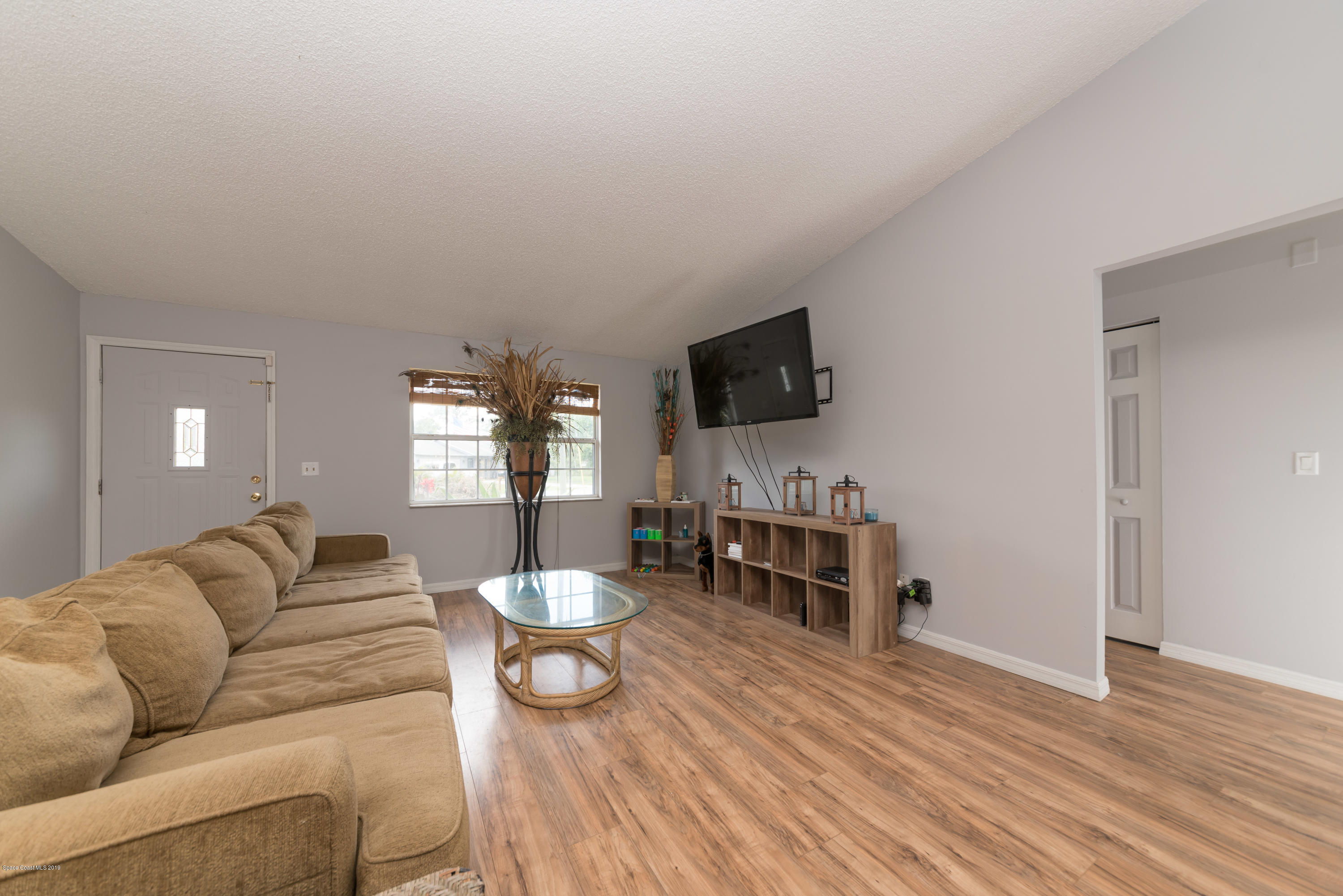 5660 Banos Avenue Cocoa, FL 32927 - Photo 12 of 22 a living room with furniture and a flat screen tv