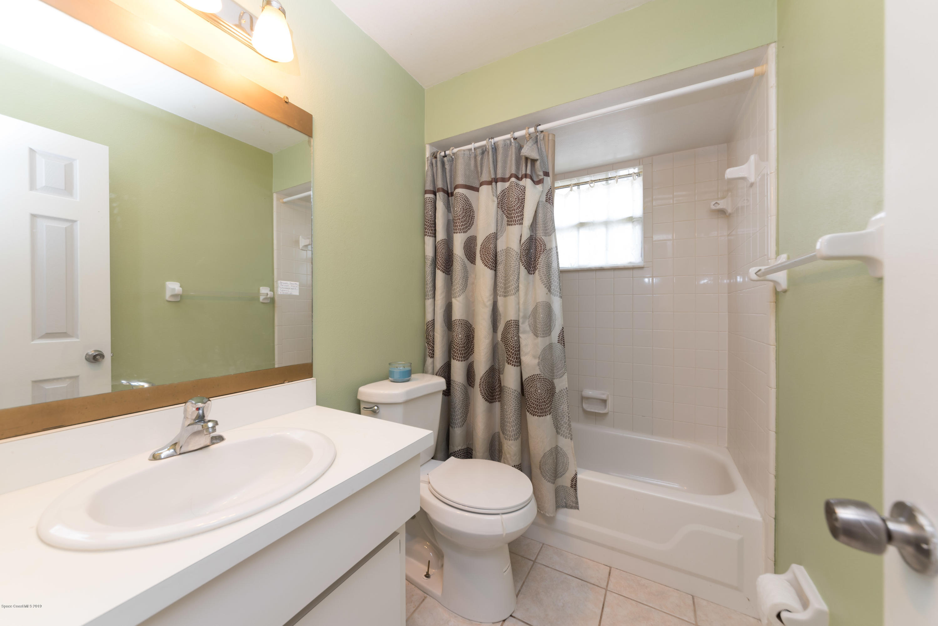 5660 Banos Avenue Cocoa, FL 32927 - Photo 14 of 22 a bathroom with a sink a toilet and shower