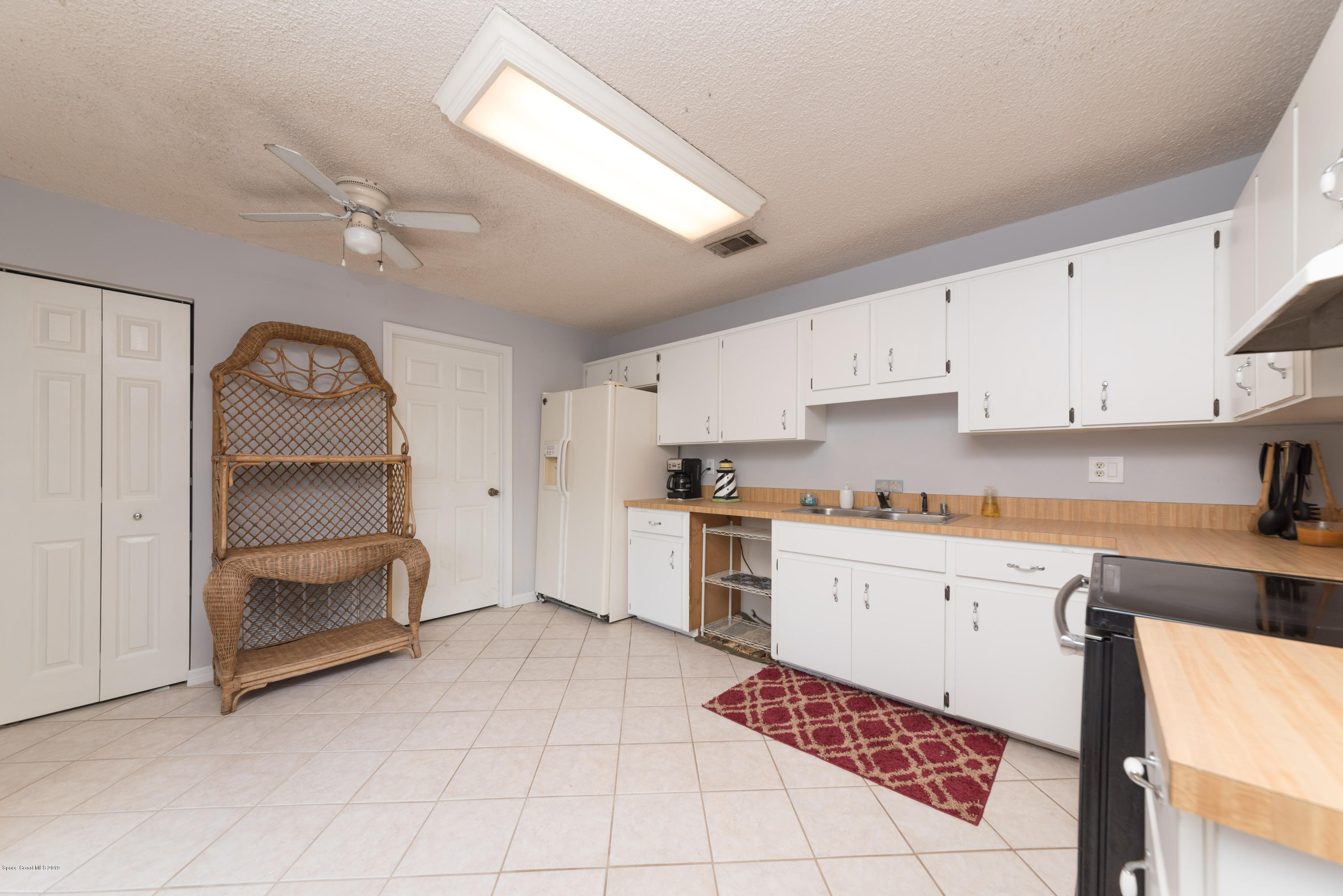 5660 Banos Avenue Cocoa, FL 32927 - Photo 15 of 22 a kitchen with a cabinets and appliances