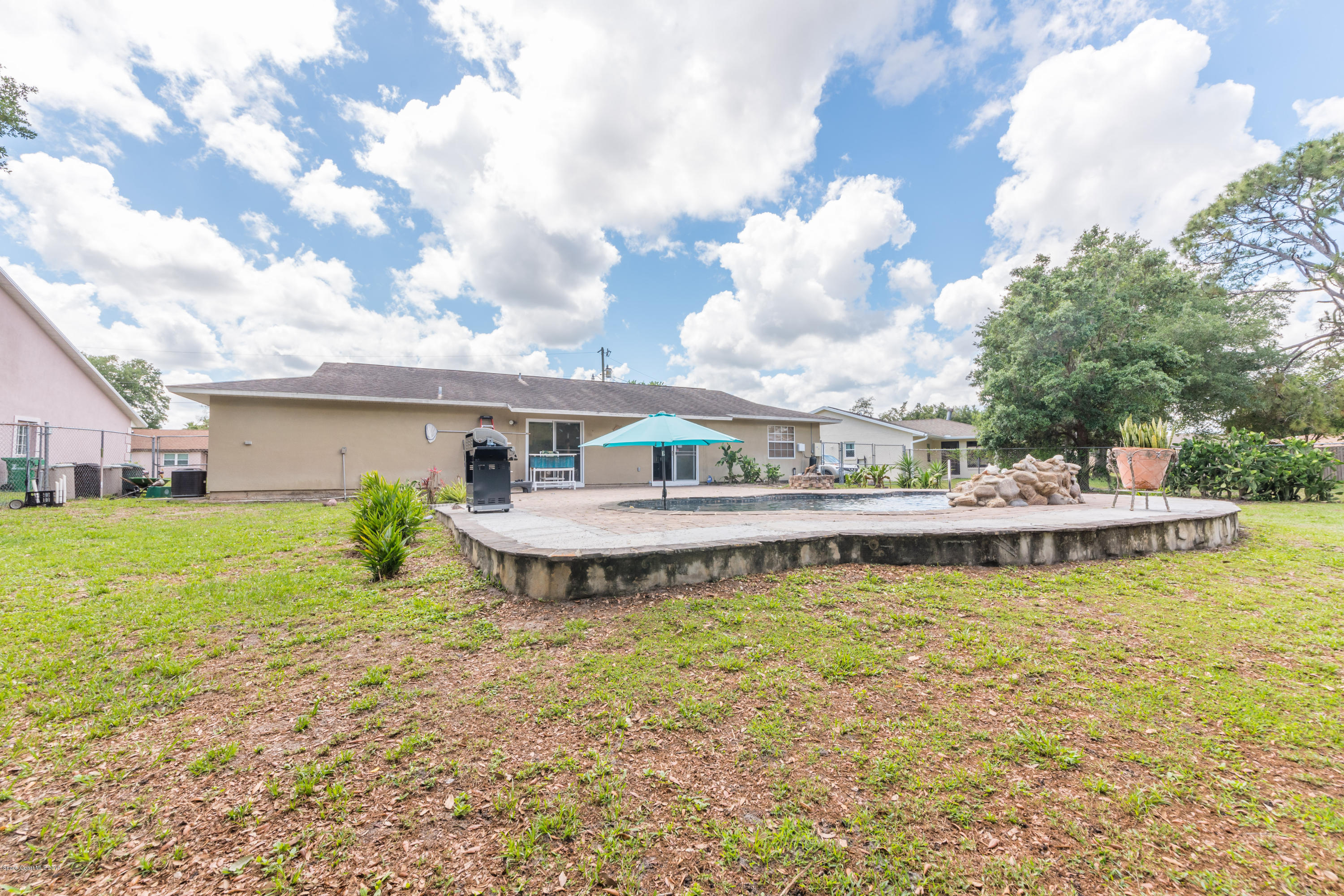 5660 Banos Avenue Cocoa, FL 32927 - Photo 3 of 22 a aerial view of a house with swimming pool and a yard