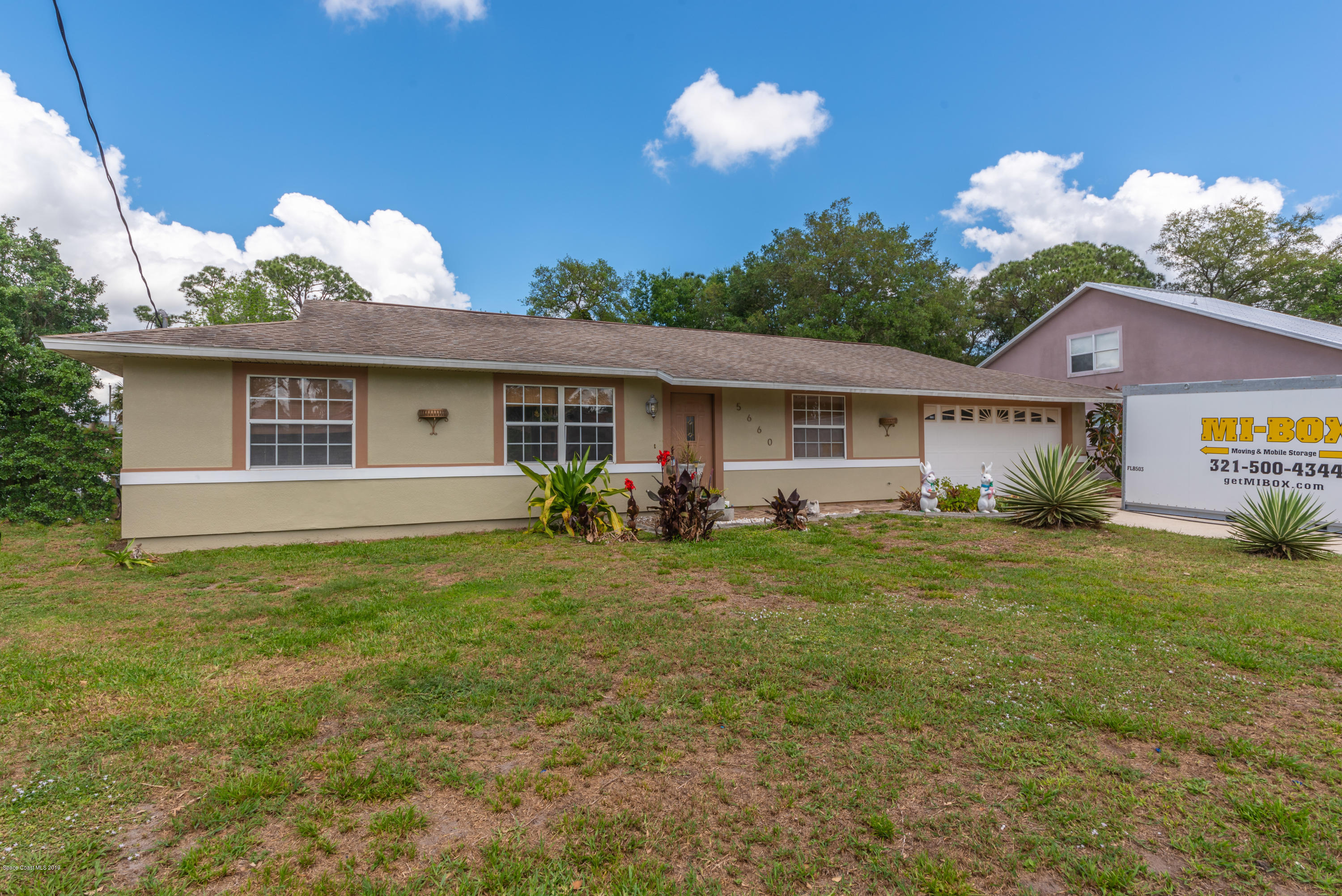 5660 Banos Avenue Cocoa, FL 32927 - Photo 10 of 22 a view of a house with a yard and a garden