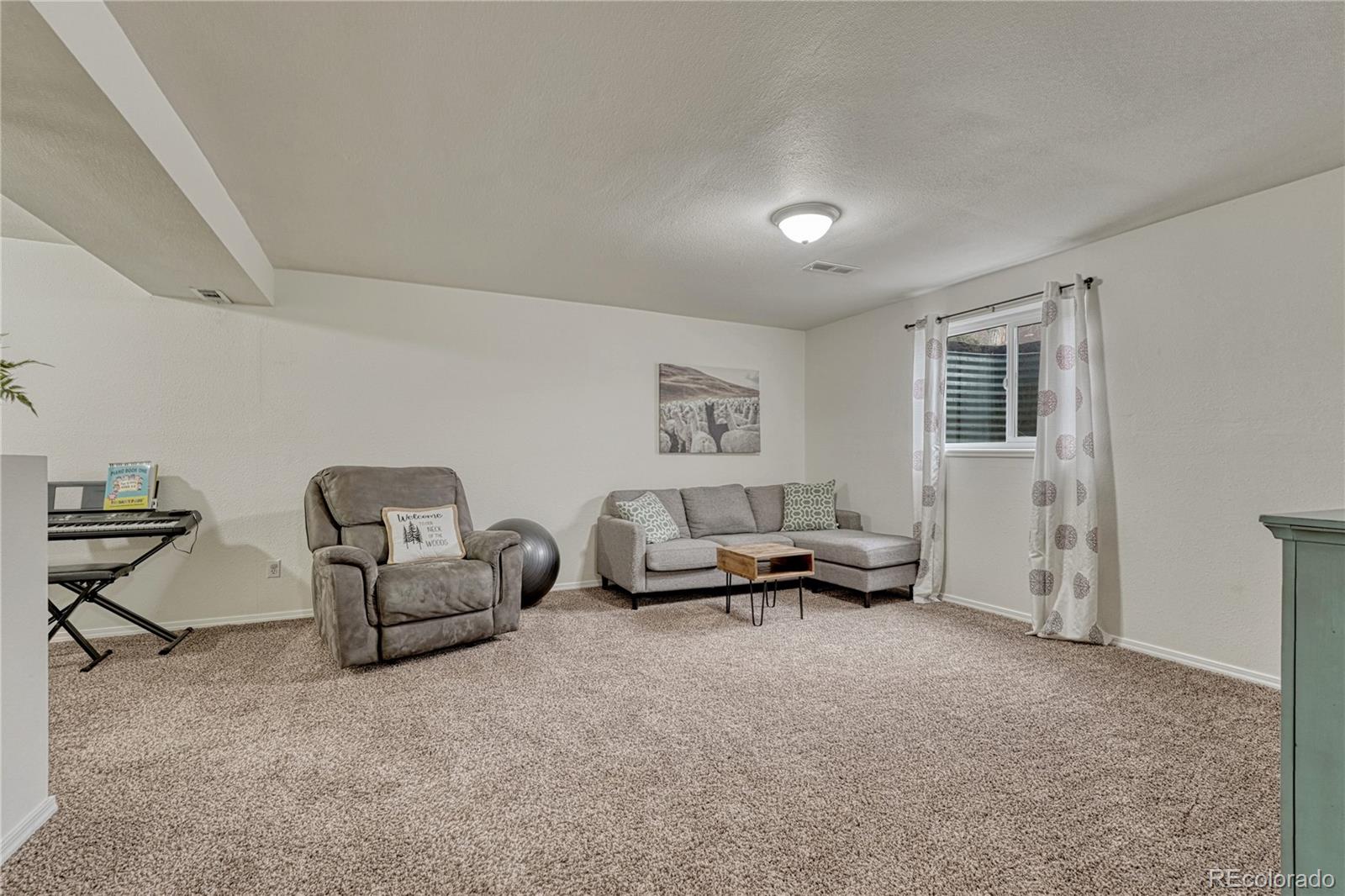 2935 Rolling Wood Loop Colorado Springs, CO 80918 - Photo 25 of 47 a living room with furniture and a window