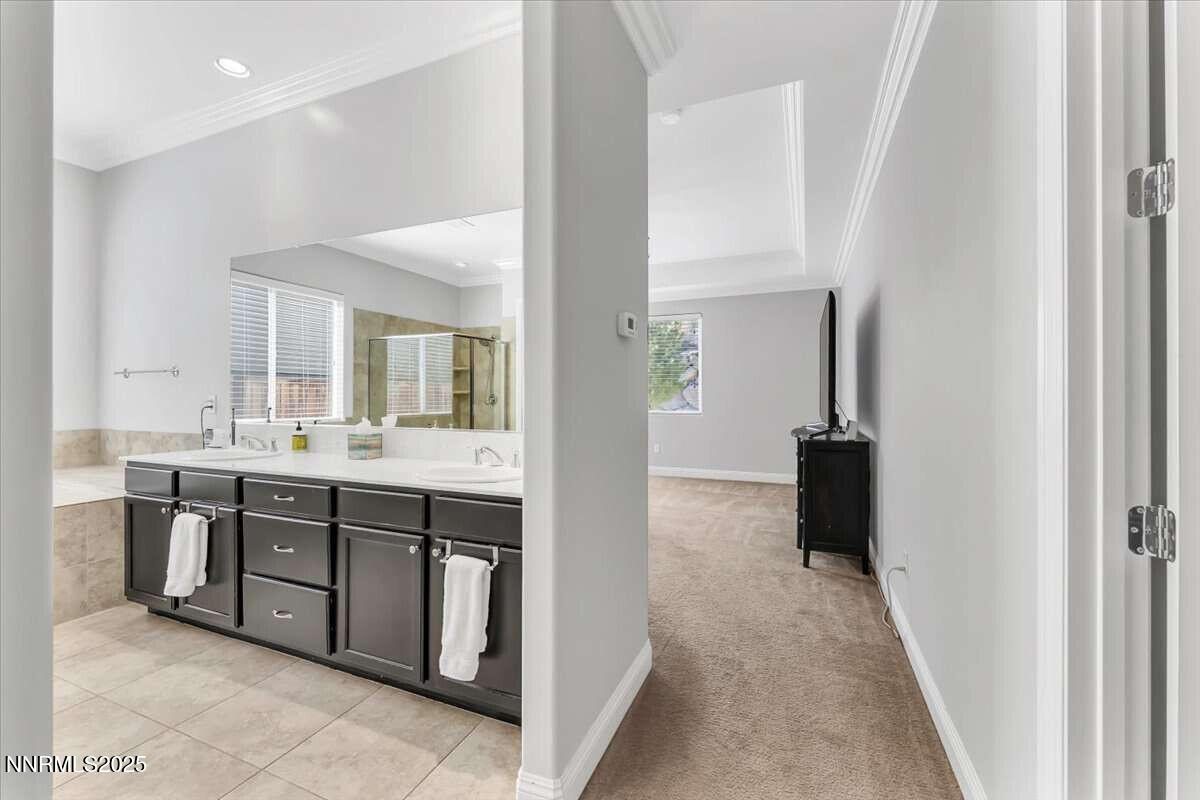 1671 Crescent Pointe Court Reno, NV 89523 - Photo 18 of 44 a spacious bathroom with a double vanity sink and a mirror