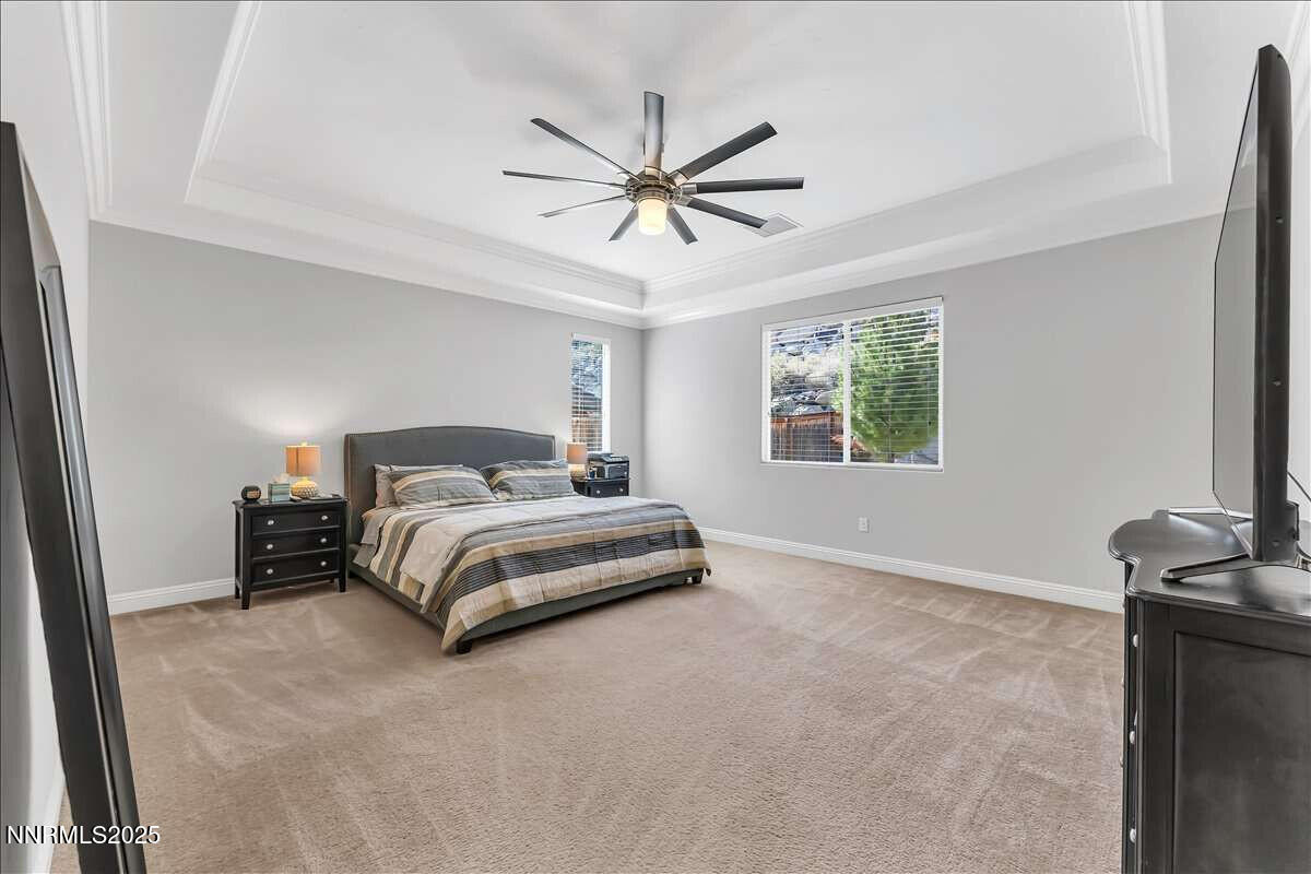1671 Crescent Pointe Court Reno, NV 89523 - Photo 19 of 44 a bedroom with a bed and ceiling fan