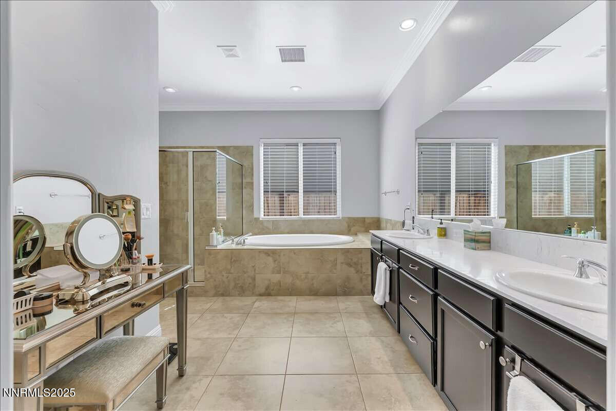 1671 Crescent Pointe Court Reno, NV 89523 - Photo 21 of 44 a large bathroom with a tub and a large mirror