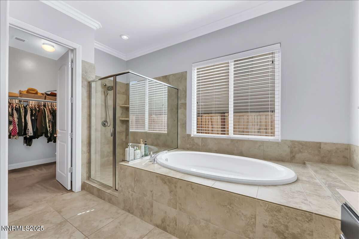 1671 Crescent Pointe Court Reno, NV 89523 - Photo 22 of 44 a spacious bathroom with a granite countertop tub sink and mirror