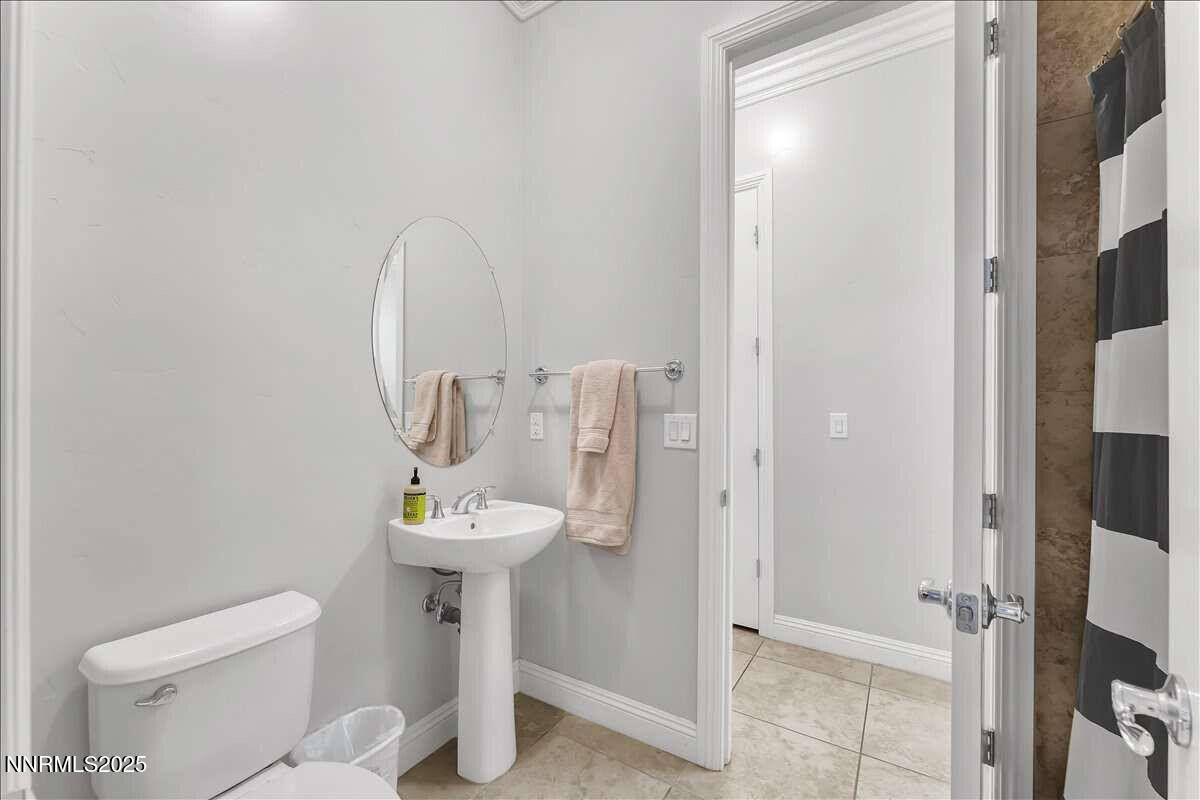 1671 Crescent Pointe Court Reno, NV 89523 - Photo 27 of 44 a bathroom with a sink toilet and a mirror