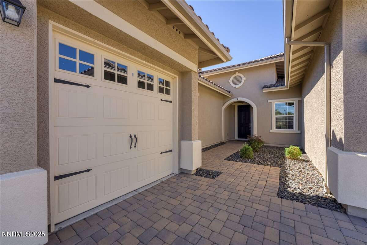 1671 Crescent Pointe Court Reno, NV 89523 - Photo 4 of 44 a front view of a house with a yard