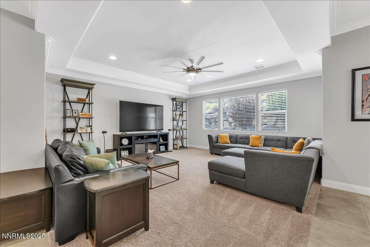 1671 Crescent Pointe Court Reno, NV 89523 - Photo 8 of 44 a living room with furniture and a flat screen tv