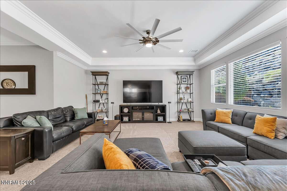 1671 Crescent Pointe Court Reno, NV 89523 - Photo 9 of 44 a living room with furniture and a flat screen tv