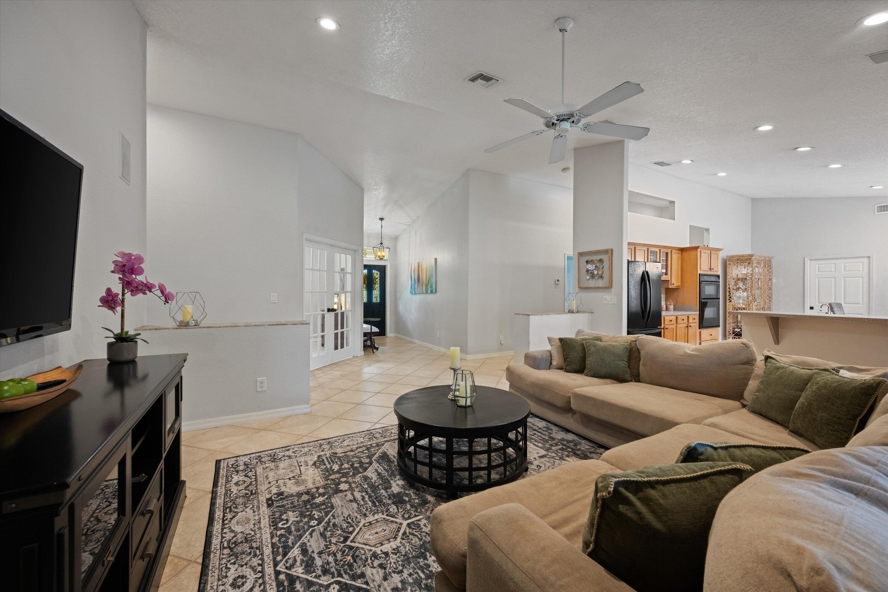 10771 154th Road North Jupiter, FL 33478 - Photo 17 of 87 a living room with furniture and a flat screen tv