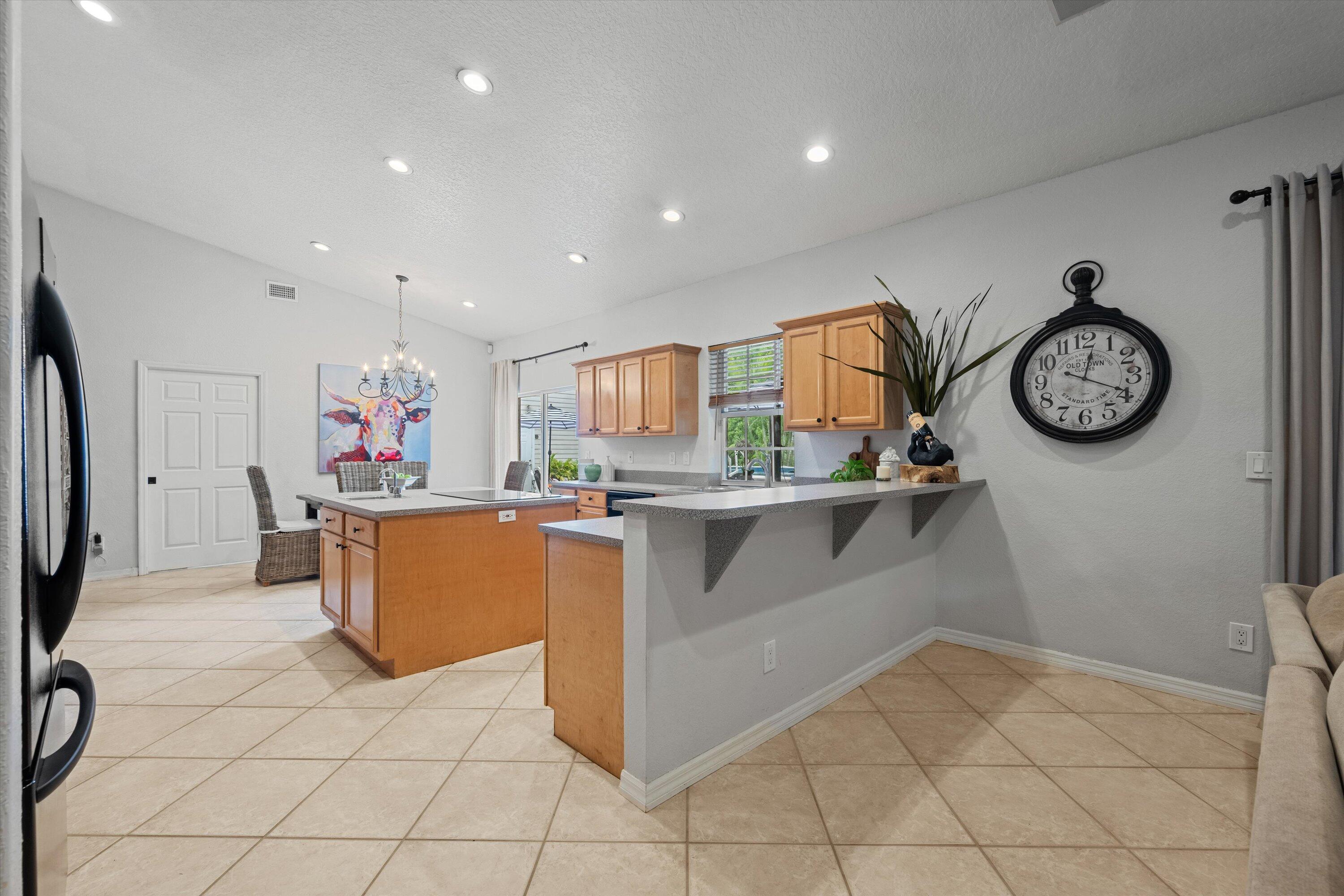 10771 154th Road North Jupiter, FL 33478 - Photo 18 of 87 a kitchen with stainless steel appliances granite countertop a refrigerator and a stove