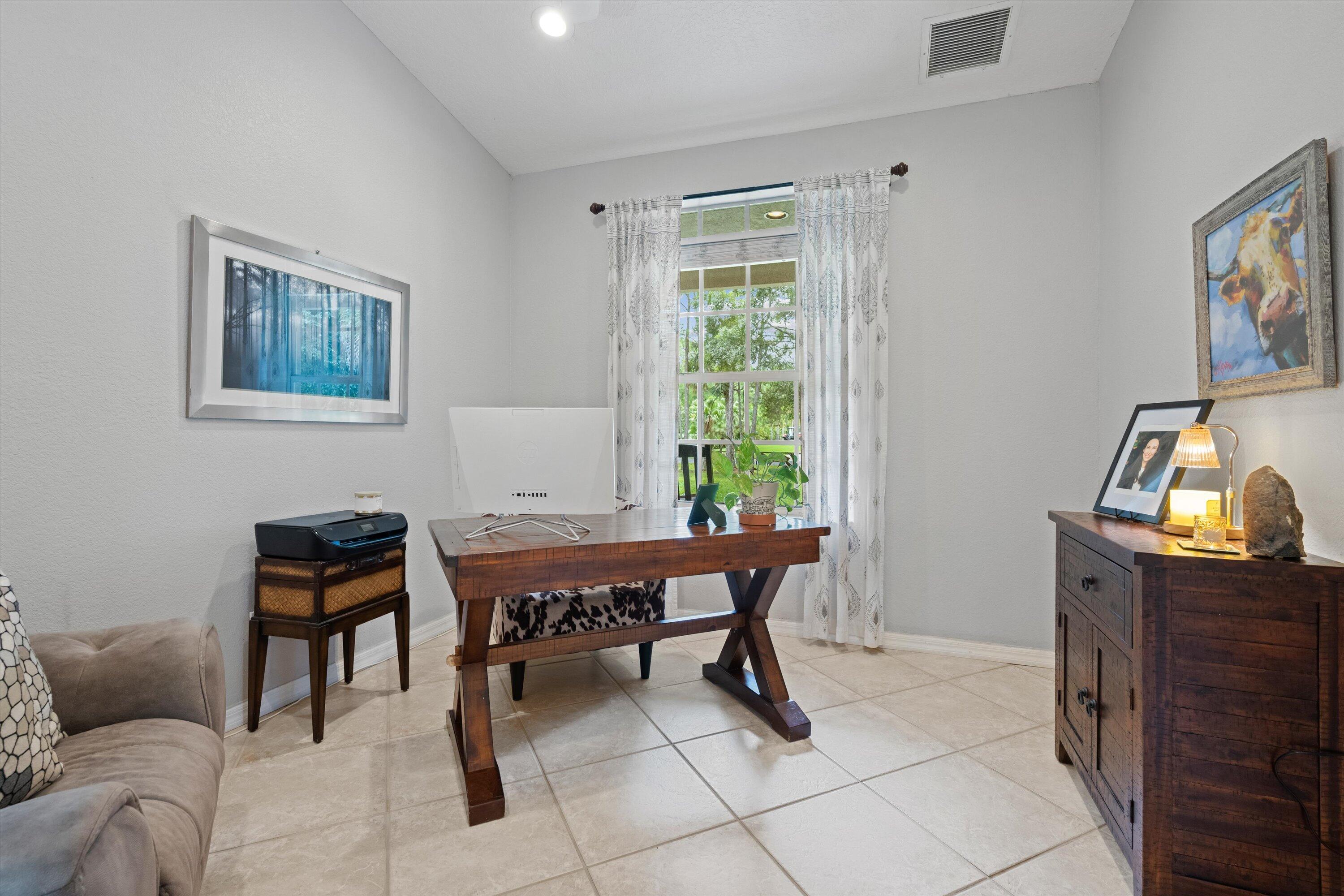 10771 154th Road North Jupiter, FL 33478 - Photo 27 of 87 a view of a workspace with furniture and a window