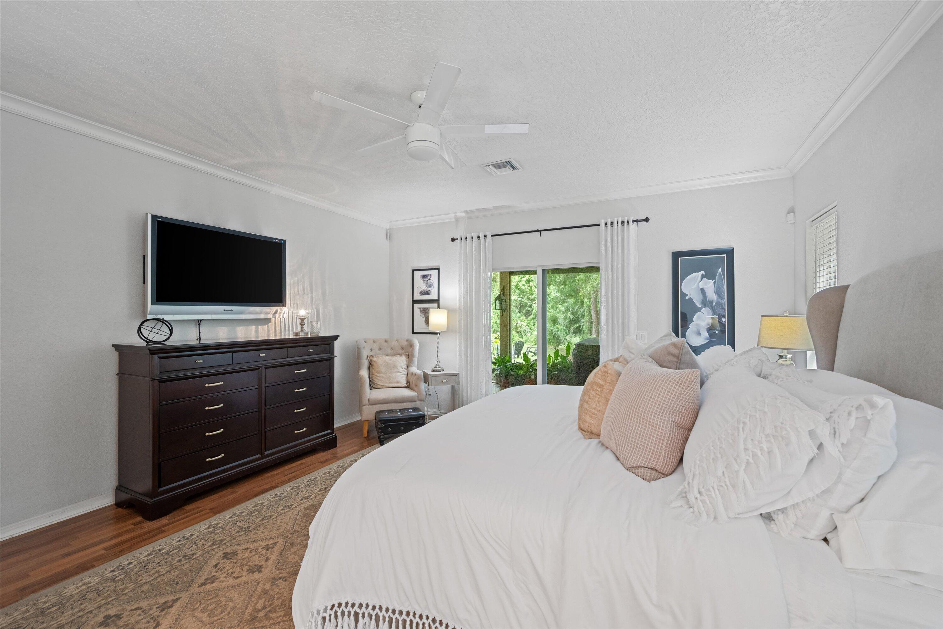 10771 154th Road North Jupiter, FL 33478 - Photo 32 of 87 a bedroom with a bed and a flat screen tv
