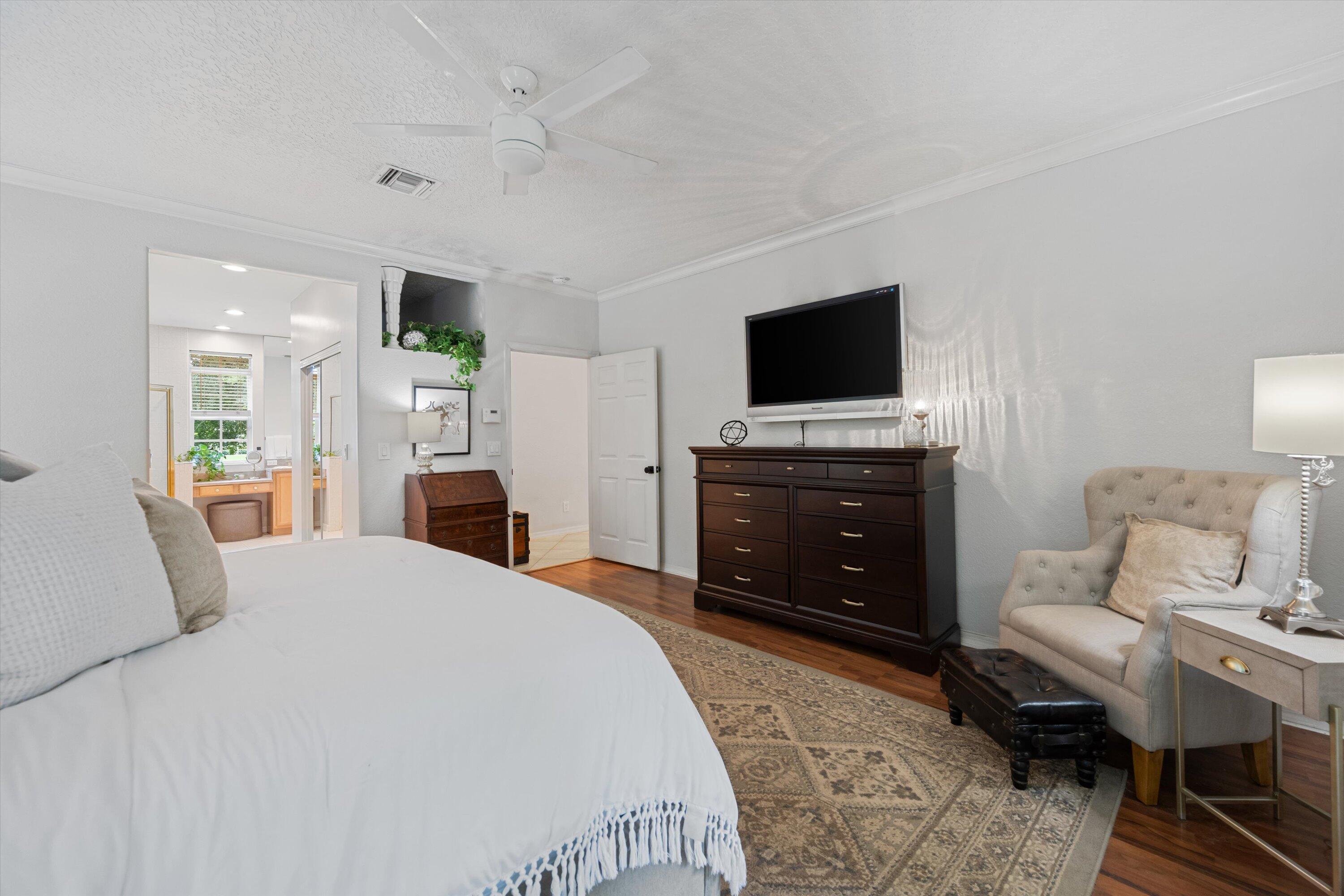 10771 154th Road North Jupiter, FL 33478 - Photo 33 of 87 a spacious bedroom with a bed and a flat screen tv