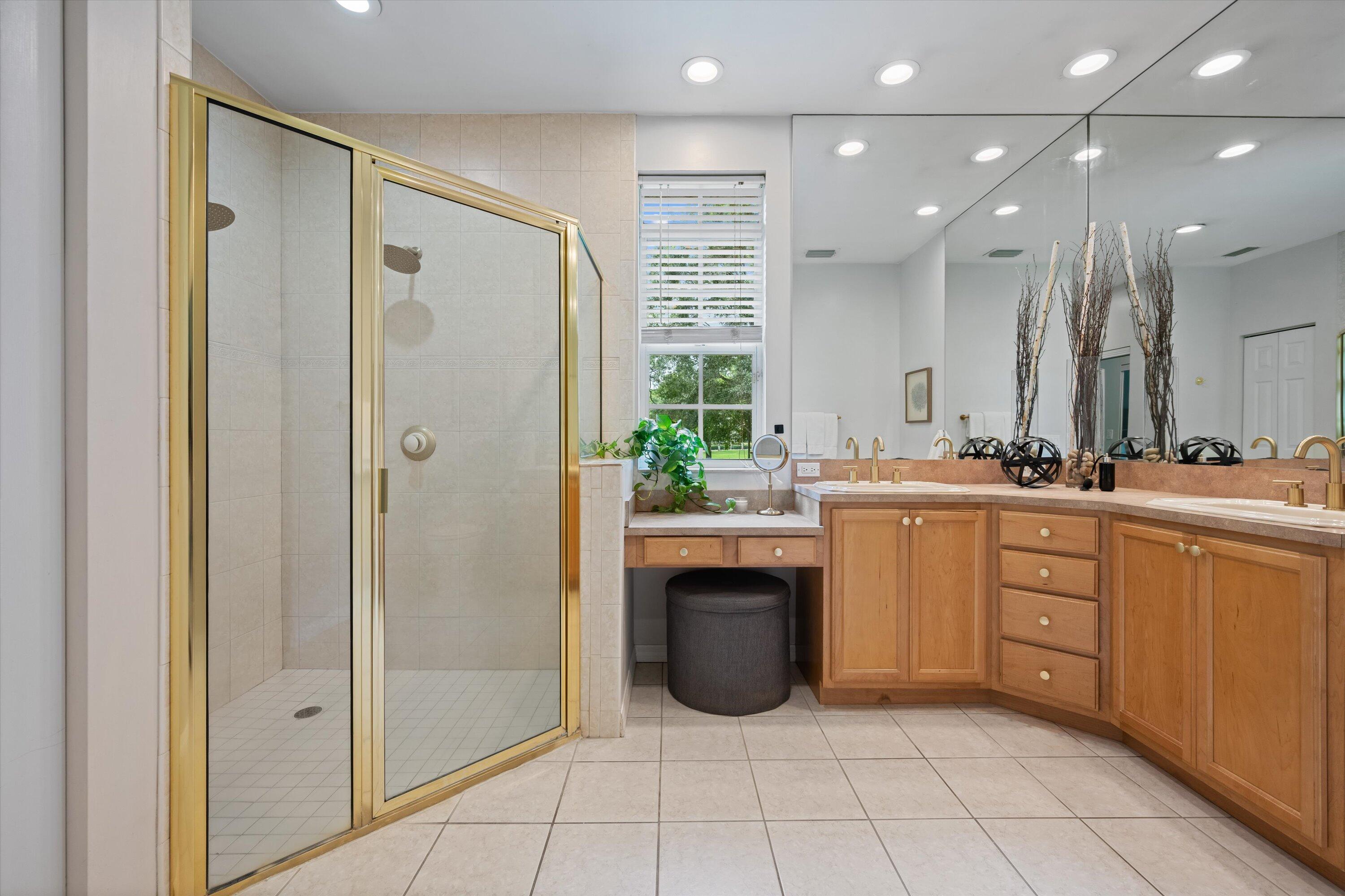 10771 154th Road North Jupiter, FL 33478 - Photo 35 of 87 a spacious bathroom with a shower sink and mirror