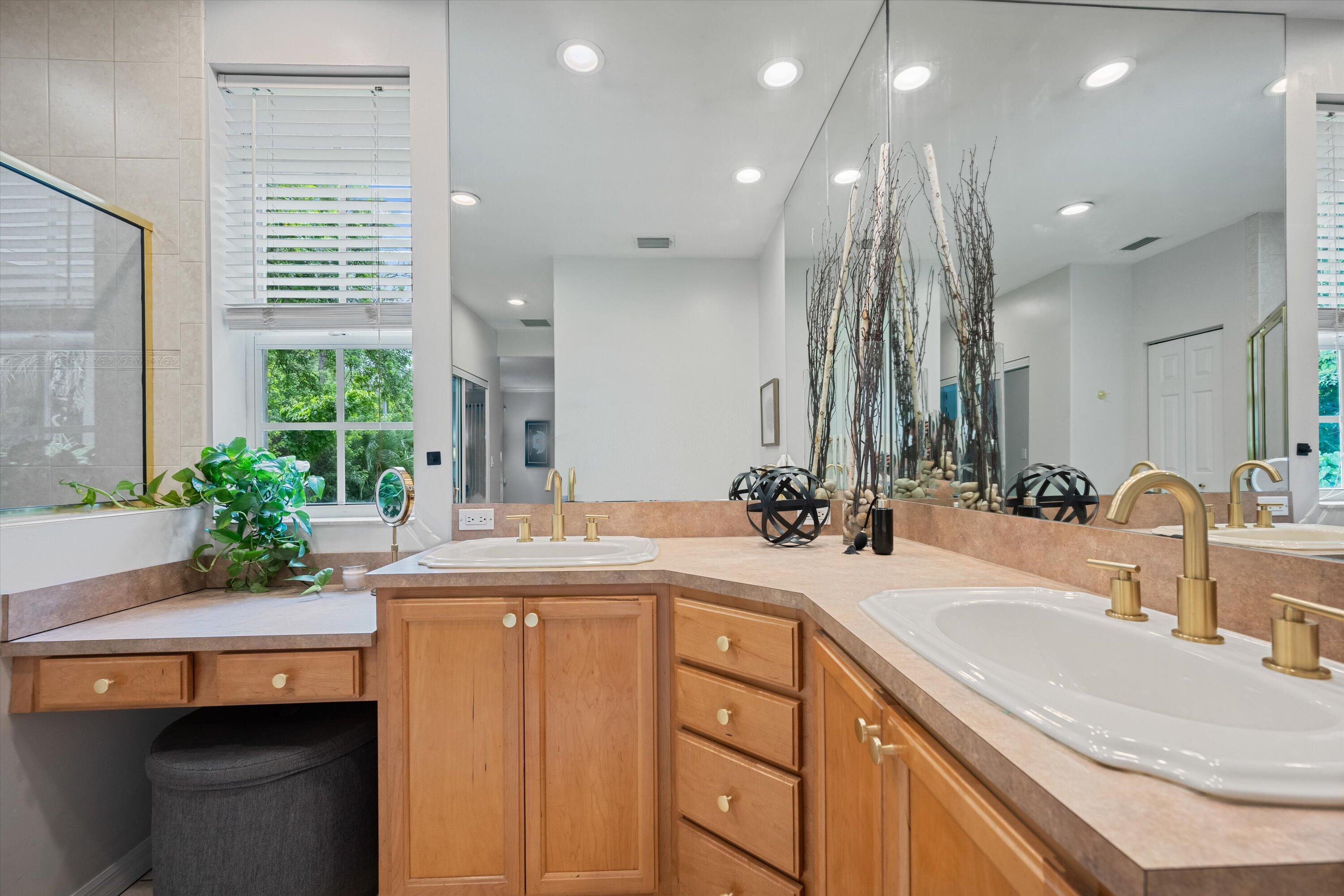10771 154th Road North Jupiter, FL 33478 - Photo 38 of 87 a bathroom with a granite countertop sink a large mirror and a shower