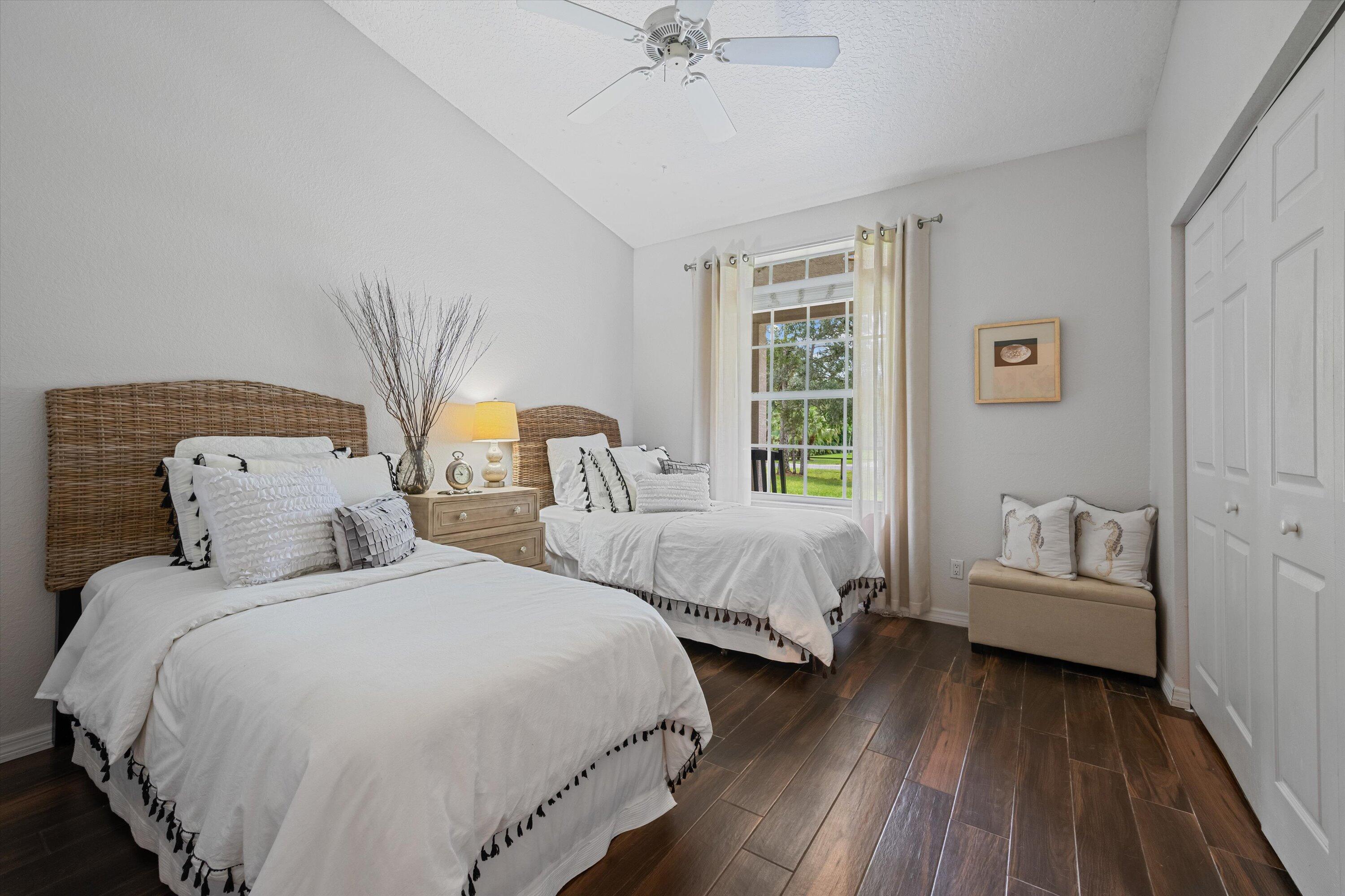 10771 154th Road North Jupiter, FL 33478 - Photo 40 of 87 a bedroom with two beds and a chandelier