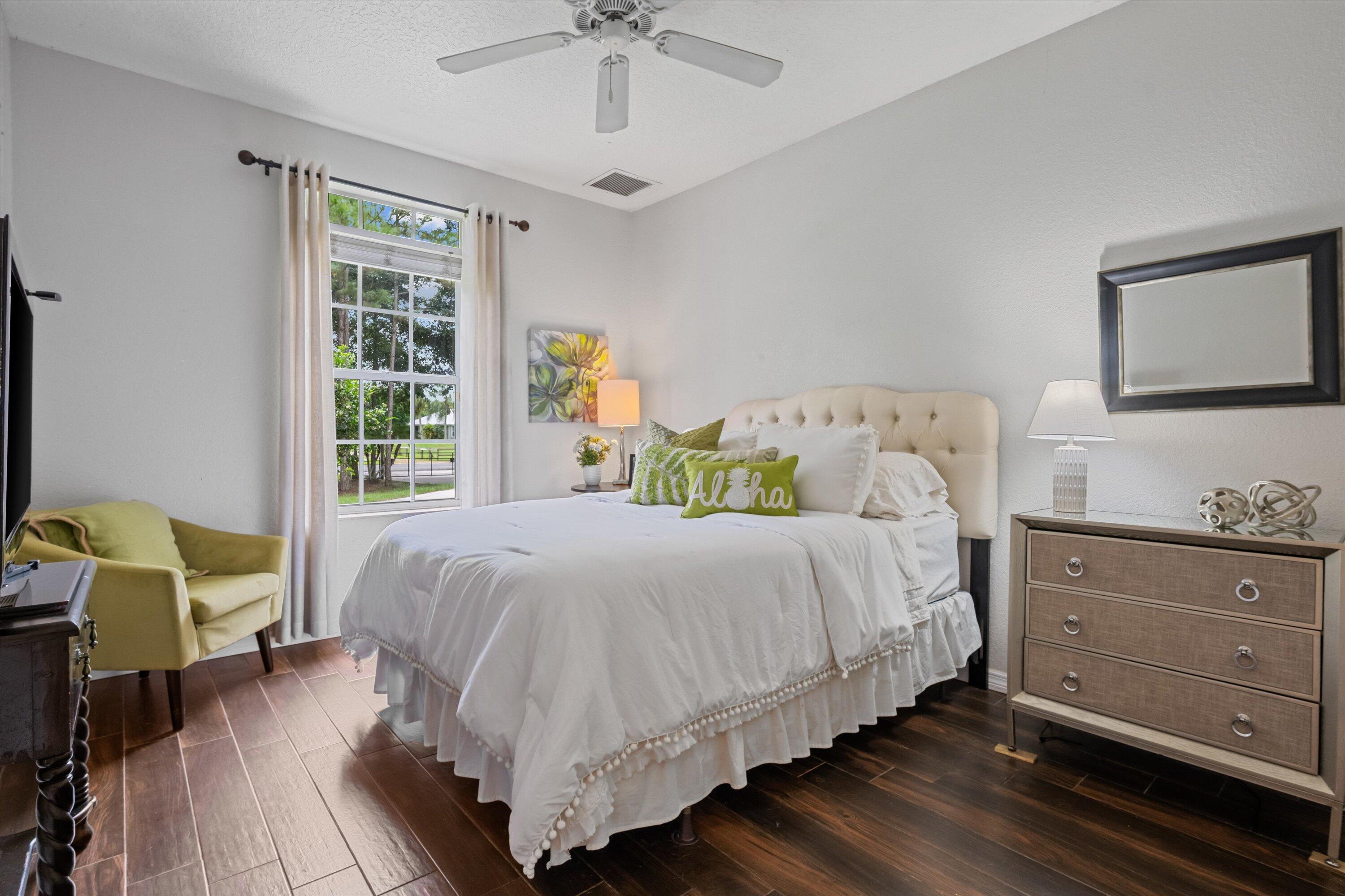 10771 154th Road North Jupiter, FL 33478 - Photo 43 of 87 a bedroom with a bed and wooden floor