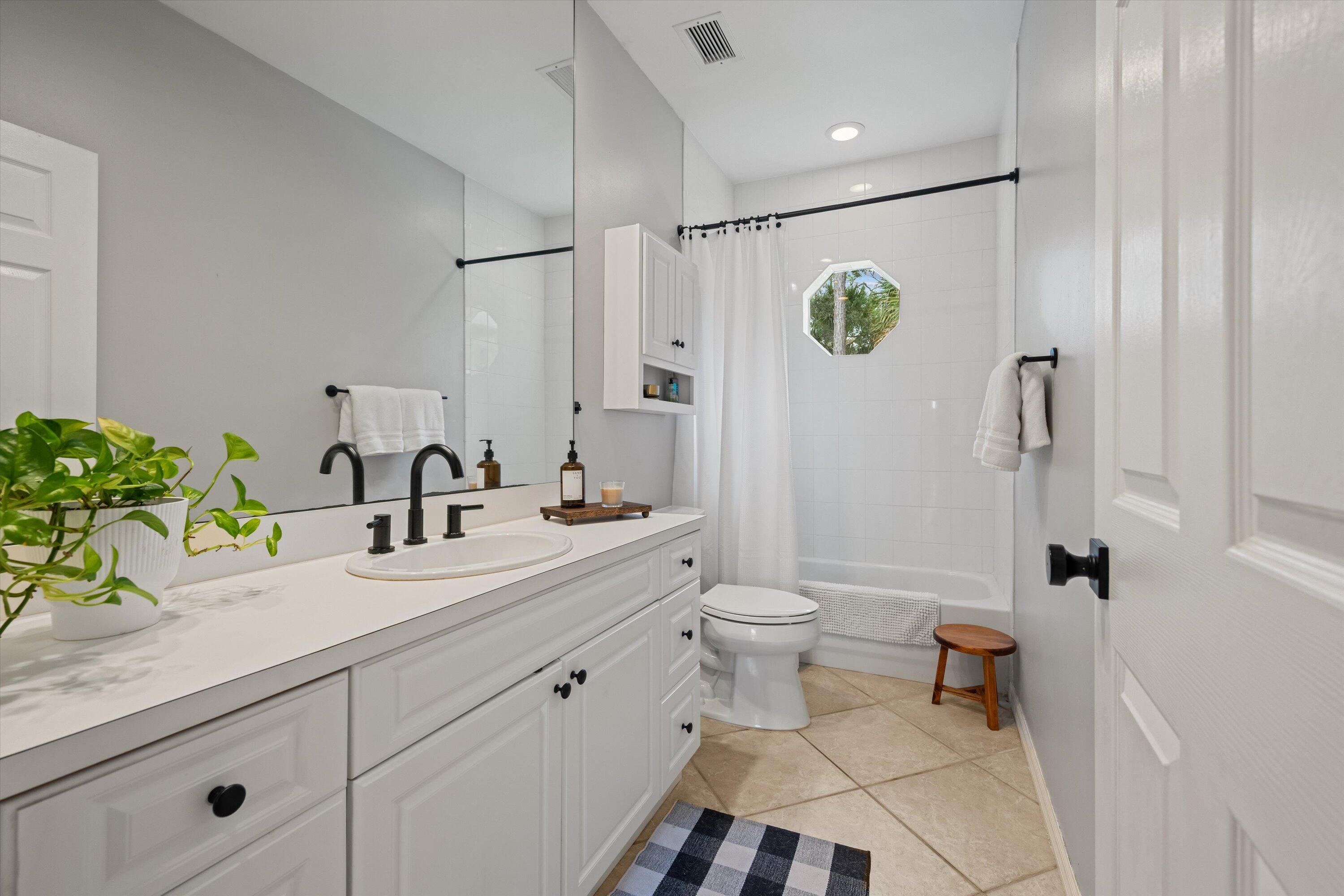 10771 154th Road North Jupiter, FL 33478 - Photo 46 of 87 a bathroom with a sink a toilet and shower