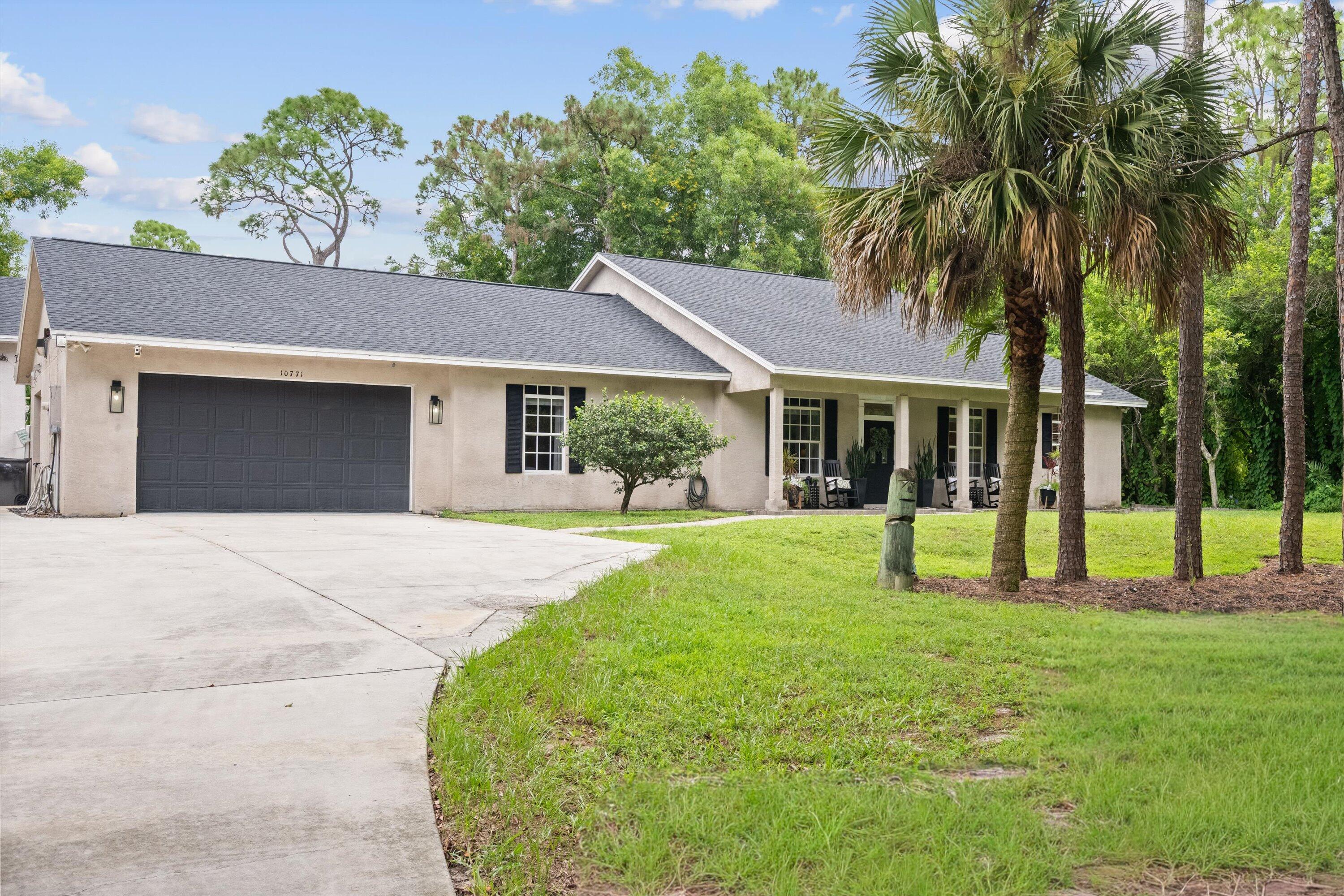 10771 154th Road North Jupiter, FL 33478 - Photo 5 of 87 a view of a house with a yard and potted plants
