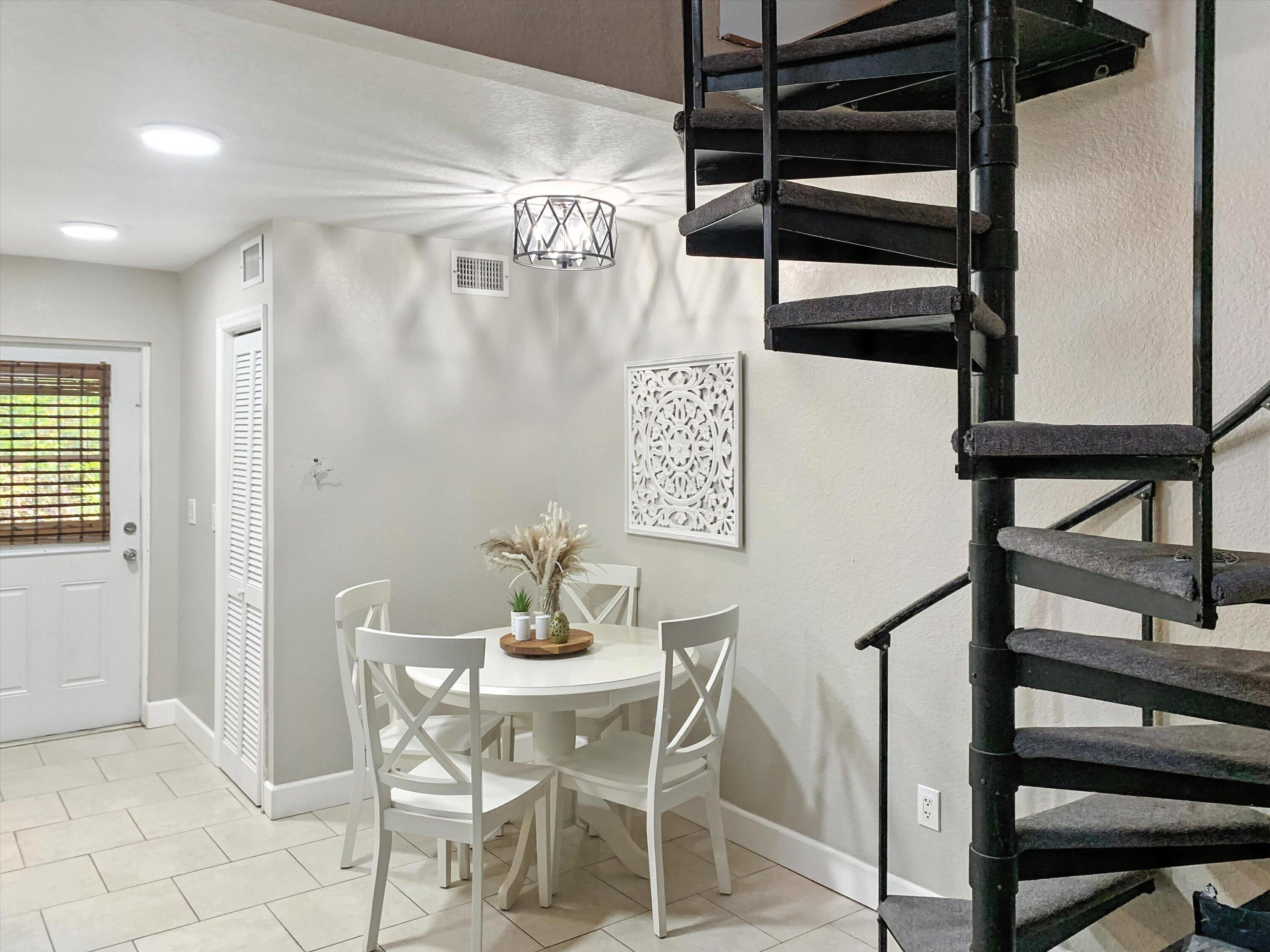10771 154th Road North Jupiter, FL 33478 - Photo 75 of 87 a view of a dining room with furniture and wooden floor