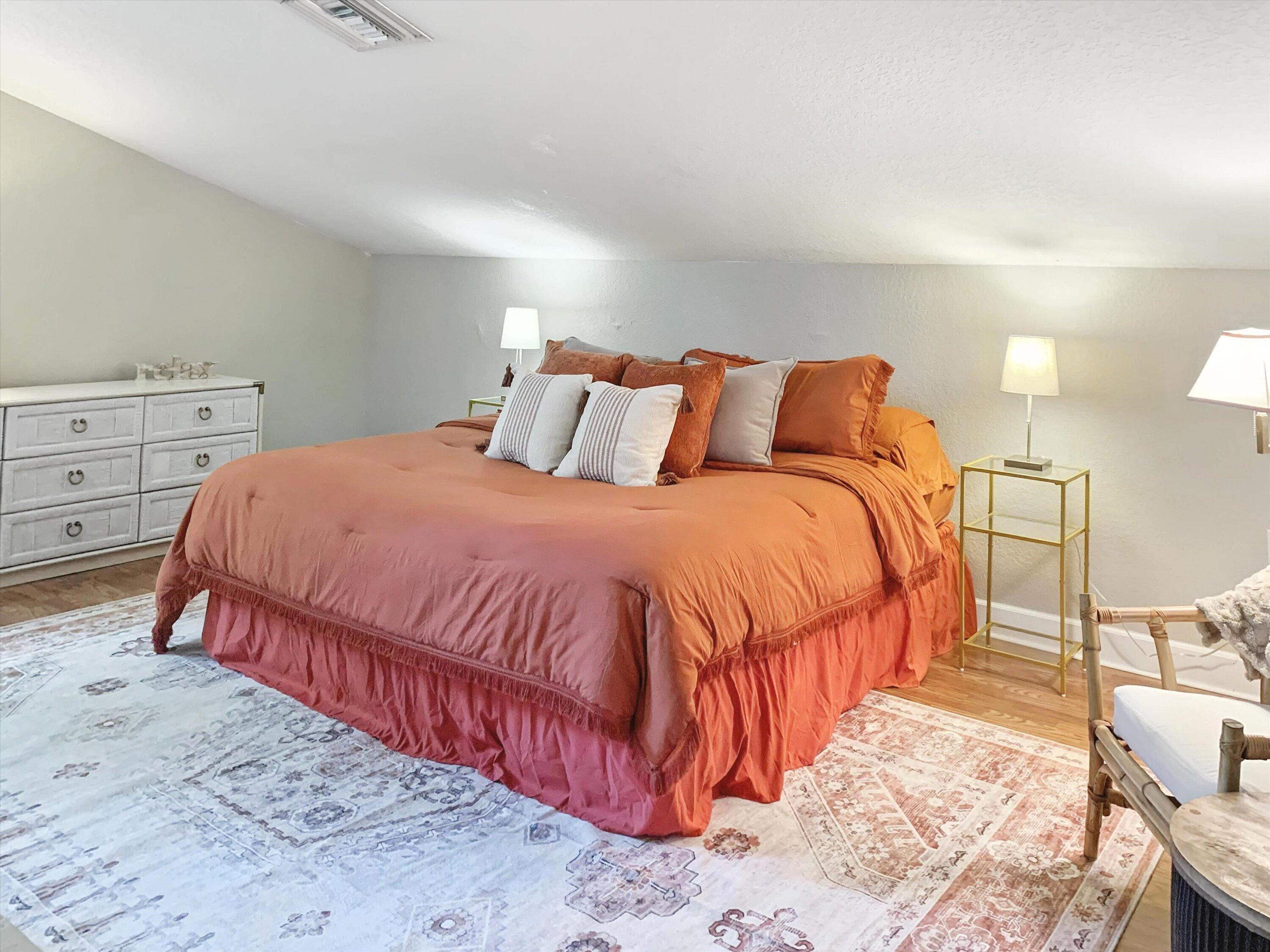 10771 154th Road North Jupiter, FL 33478 - Photo 76 of 87 a bedroom with a bed and a lamp on dresser