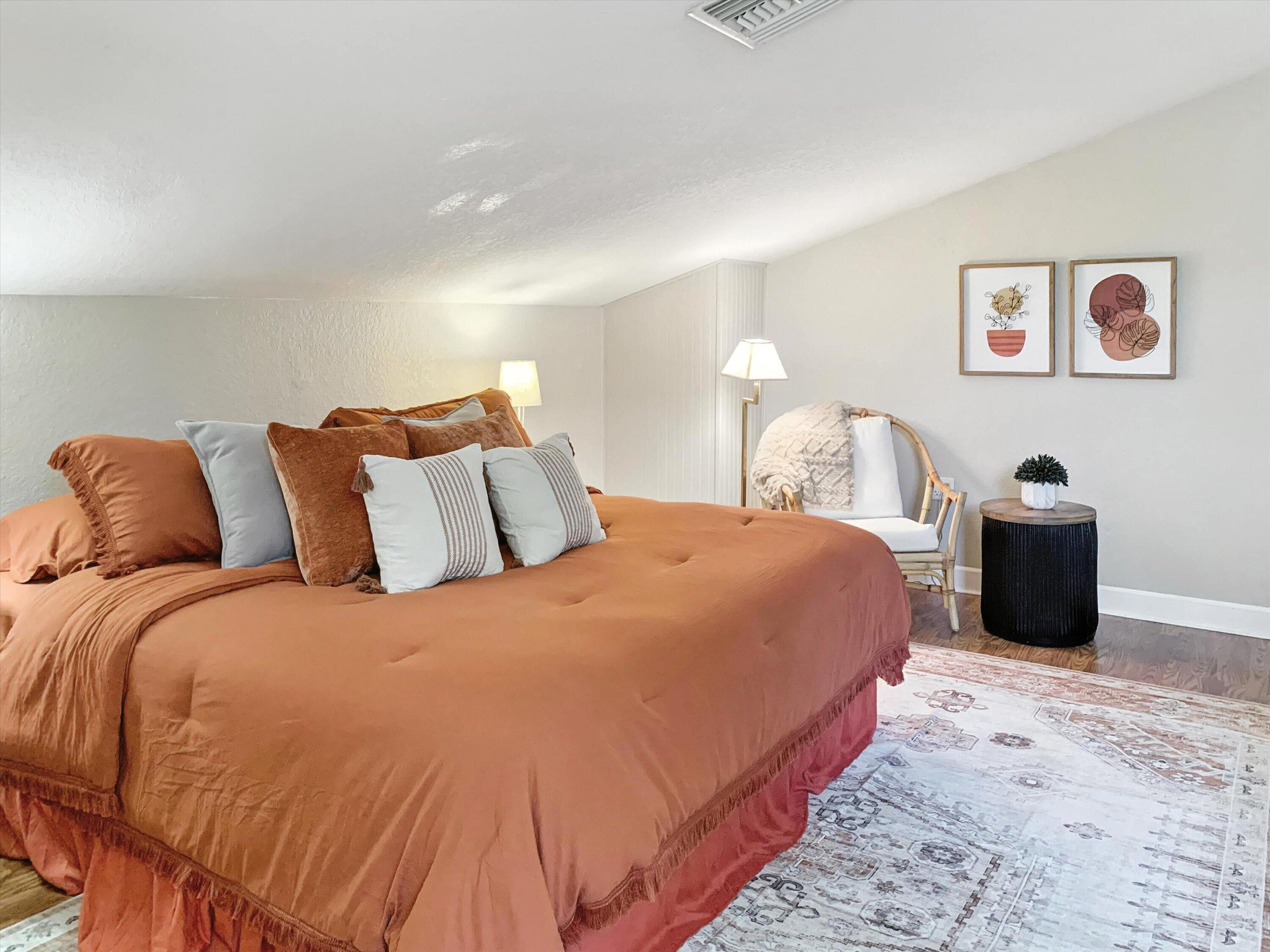 10771 154th Road North Jupiter, FL 33478 - Photo 77 of 87 a large bed sitting in a bedroom next to a lamp