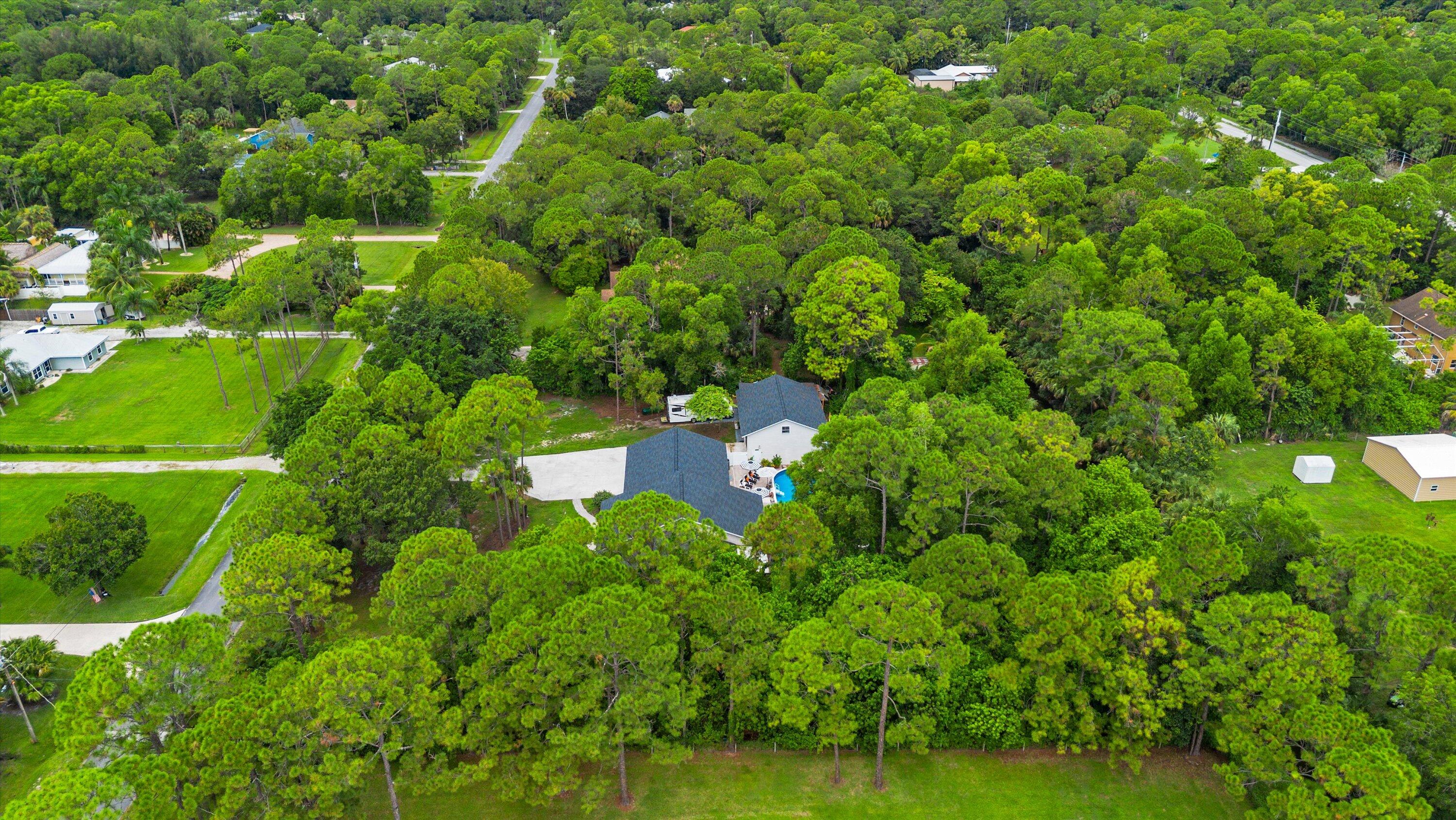 10771 154th Road North Jupiter, FL 33478 - Photo 86 of 87 a backyard of a house with lots of green space and a lake view