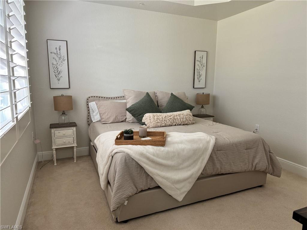 Undisclosed Address Naples, FL 34114 - Photo 12 of 25 a bedroom with a bed and wooden floor