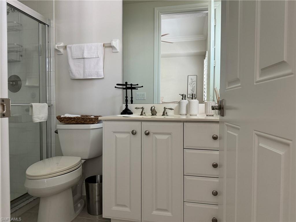 Undisclosed Address Naples, FL 34114 - Photo 13 of 25 a bathroom with a toilet sink and mirror