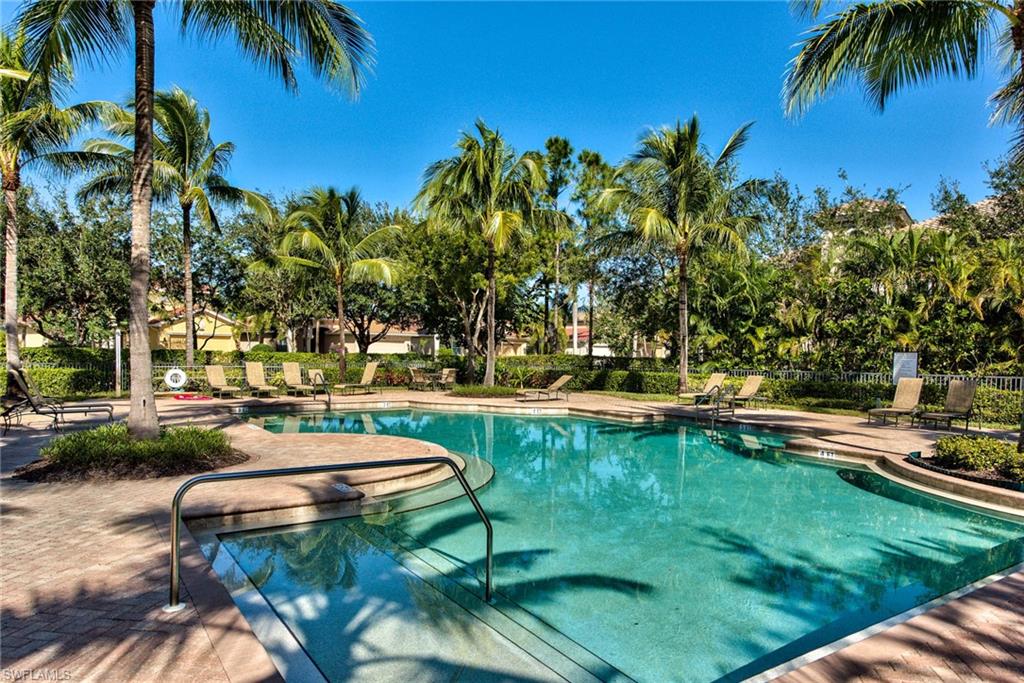 Undisclosed Address Naples, FL 34114 - Photo 14 of 25 a view of a swimming pool with a garden and trees