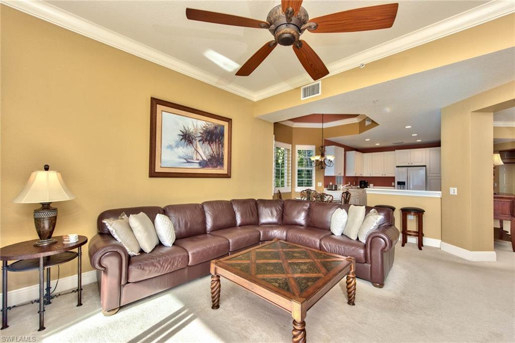 Undisclosed Address Naples, FL 34114 - Photo 2 of 25 a living room with furniture and a chandelier