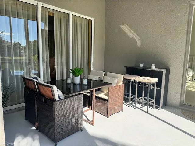 a living room with couches and a dining table with garden view