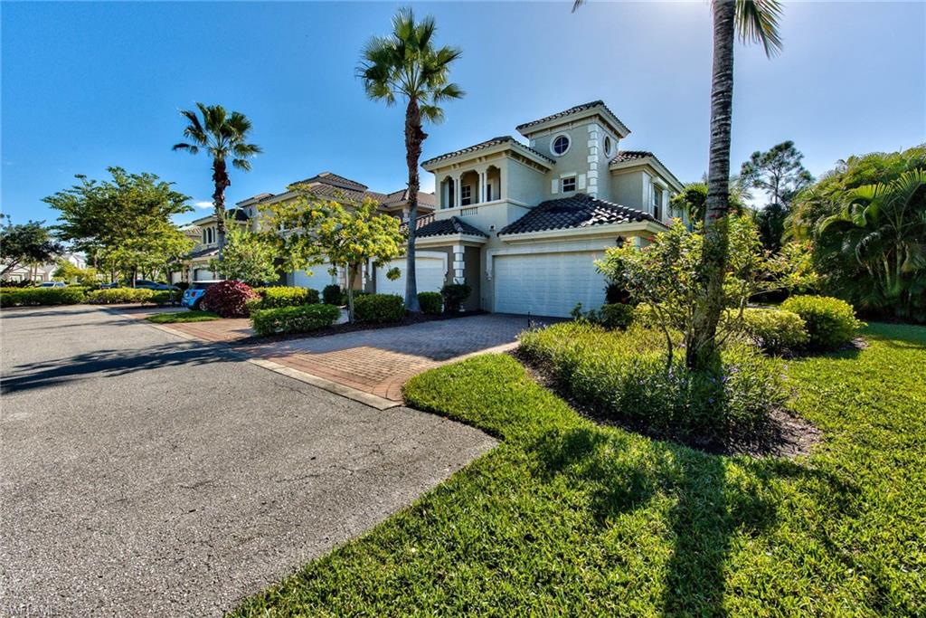 Undisclosed Address Naples, FL 34114 - Photo 23 of 25 a front view of a house with a yard and potted plants