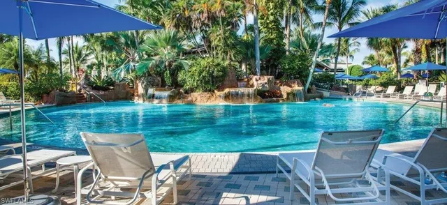 a view of a patio with table and chairs under an umbrella