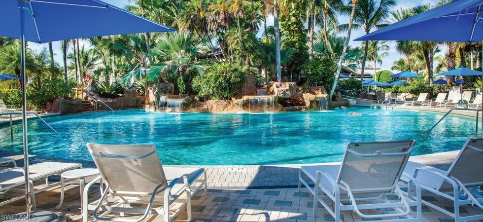 Undisclosed Address Naples, FL 34114 - Photo 25 of 25 a view of a patio with table and chairs under an umbrella